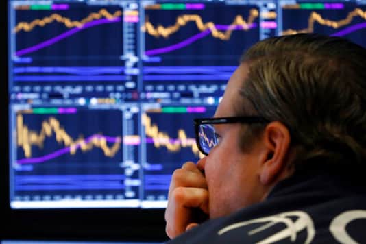 FILE - In this Tuesday, Jan. 28, 2020, file photo, specialist Gregg Maloney watches the screens at his post on the floor of the New York Stock Exchange. Companies are lining up for earnings reporting season, and analysts expect them to describe a smaller drop for the summer than they reported for the spring, when widespread business shutdowns amid the coronavirus pandemic paralyzed the economy. (AP Photo/Richard Drew, File) FILE - In this Tuesday, Jan. 28, 2020, file photo, specialist Gregg Maloney watches the screens at his post on the floor of the New York Stock Exchange. Companies are lining up for earnings reporting season, and analysts expect them to describe a smaller drop for the summer than they reported for the spring, when widespread business shutdowns amid the coronavirus pandemic paralyzed the economy. (AP Photo/Richard Drew, File)