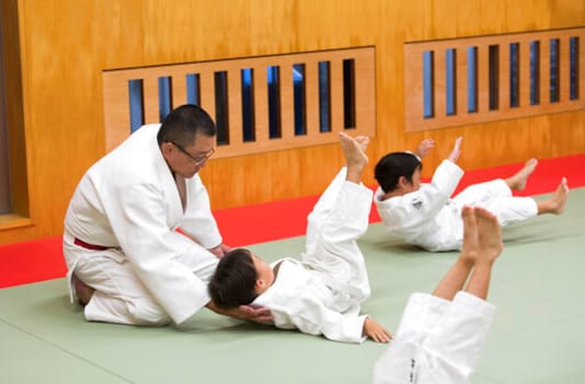Judo teacher Tomoo Hamana helps protect the neck of a new student during a judo lesson at Hamana Dojo in Oiso town, west of Tokyo on Oct. 1, 2020. Japan is the home of judo, and the 19th-century martial art is sure to get more attention at home than any other sport at next years postponed Tokyo Olympics. But its also drawing unwanted scrutiny over widespread allegations of violence, and accompanying injuries and abuse. (AP Photo/Hiro Komae) Judo teacher Tomoo Hamana helps protect the neck of a new student during a judo lesson at Hamana Dojo in Oiso town, west of Tokyo on Oct. 1, 2020. Japan is the home of judo, and the 19th-century martial art is sure to get more attention at home than any other sport at next years postponed Tokyo Olympics. But its also drawing unwanted scrutiny over widespread allegations of violence, and accompanying injuries and abuse. (AP Photo/Hiro Komae)