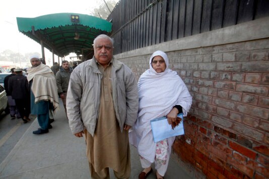 FILE - In this Jan.1, 2020 file photo, Professor Mohammad Ismail and his wife Uzlifat Ismail, parents of the Pakistani human rights activist Gulalai Ismail, arrive at a court in Peshawar, Pakistan. Ismail, an elderly human rights worker said Friday, Oct. 2, 2020 that his wife and their daughter, who has already fled to America after being targeted by the country's powerful military for investigations into rights abuses by solders, faces a fresh wave of terrorism related charges. (AP Photo/Muhammad Sajjad, File) FILE - In this Jan.1, 2020 file photo, Professor Mohammad Ismail and his wife Uzlifat Ismail, parents of the Pakistani human rights activist Gulalai Ismail, arrive at a court in Peshawar, Pakistan. Ismail, an elderly human rights worker said Friday, Oct. 2, 2020 that his wife and their daughter, who has already fled to America after being targeted by the country's powerful military for investigations into rights abuses by solders, faces a fresh wave of terrorism related charges. (AP Photo/Muhammad Sajjad, File)