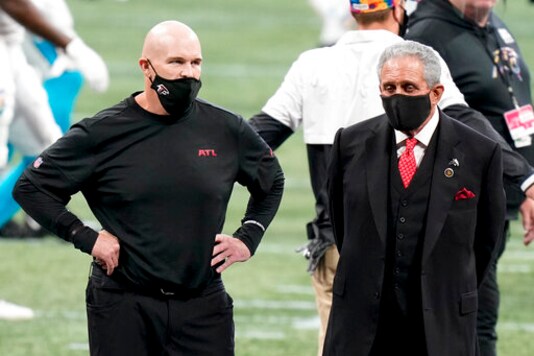 Atlanta Falcons head coach Dan Quinn stands with Atlanta Falcons Owner Arthur Blank before the first half of an NFL football game between the Atlanta Falcons and the Carolina Panthers, Sunday, Oct. 11, 2020, in Atlanta. (AP Photo/Brynn Anderson)