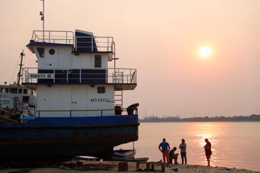 Workers rest at sunset on the shore of the Paraguay River in Asuncion, Paraguay, Wednesday, Oct. 7, 2020. The Paraguay River reached its lowest level in 50 years on Friday, Oct. 9, 2020, following months of extreme drought, which has exposed the nations economic dependence on the river and limited access to drinking water. (AP Photo/Jorge Saenz) Workers rest at sunset on the shore of the Paraguay River in Asuncion, Paraguay, Wednesday, Oct. 7, 2020. The Paraguay River reached its lowest level in 50 years on Friday, Oct. 9, 2020, following months of extreme drought, which has exposed the nations economic dependence on the river and limited access to drinking water. (AP Photo/Jorge Saenz)