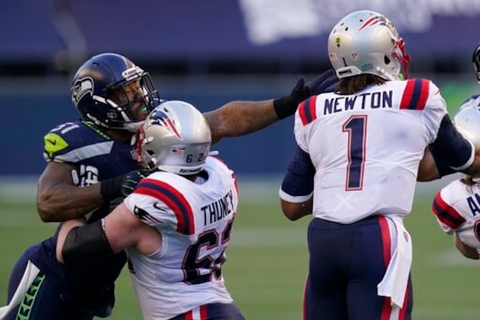 FILE - In this Sunday, Sept. 20, 2020, file photo, Seattle Seahawks linebacker Bruce Irvin, letft, is blocked by New England Patriots offensive guard Joe Thuney as he pressures quarterback Cam Newton (1) during the first half of an NFL football game, in Seattle. A big part of the success the Patriots have enjoyed on offense this season has to do with the discipline of its offensive line. (AP Photo/Elaine Thompson, File) FILE - In this Sunday, Sept. 20, 2020, file photo, Seattle Seahawks linebacker Bruce Irvin, letft, is blocked by New England Patriots offensive guard Joe Thuney as he pressures quarterback Cam Newton (1) during the first half of an NFL football game, in Seattle. A big part of the success the Patriots have enjoyed on offense this season has to do with the discipline of its offensive line. (AP Photo/Elaine Thompson, File)