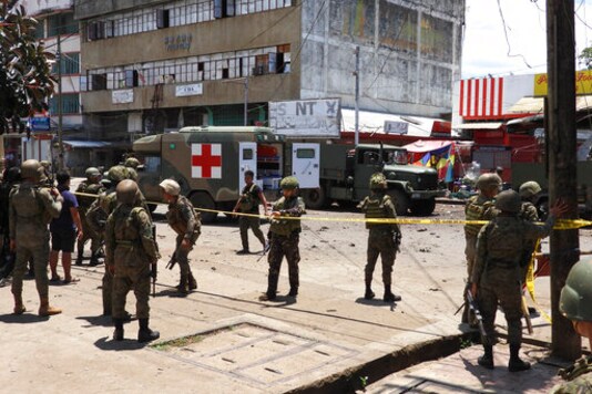 Police and military secure the site of an explosion in the town of Jolo, Sulu province southern Philippines on Monday Aug. 24, 2020. Bombs exploded in a southern Philippine town Monday, killing several soldiers and wounding other military personnel and civilians despite extra tight security due to recent threats from Abu Sayyaf militants. (AP Photo/Nickee Butlangan) Police and military secure the site of an explosion in the town of Jolo, Sulu province southern Philippines on Monday Aug. 24, 2020. Bombs exploded in a southern Philippine town Monday, killing several soldiers and wounding other military personnel and civilians despite extra tight security due to recent threats from Abu Sayyaf militants. (AP Photo/Nickee Butlangan)