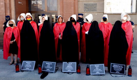 File-In this file photo from July 24, 2020, women dressed to evoke the feminist dystopian story File-In this file photo from July 24, 2020, women dressed to evoke the feminist dystopian story