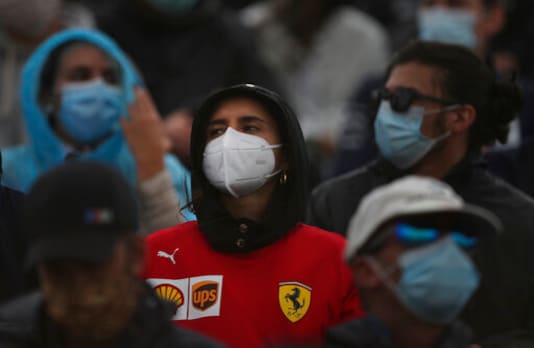 Fans wearing protective face masks watch the Formula One Portuguese Grand Prix at the Algarve International Circuit in Portimao, Portugal, Sunday, Oct. 25, 2020. (Jose Sena Goulao, Pool via AP) Fans wearing protective face masks watch the Formula One Portuguese Grand Prix at the Algarve International Circuit in Portimao, Portugal, Sunday, Oct. 25, 2020. (Jose Sena Goulao, Pool via AP)