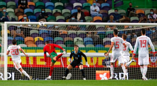 Portugal's Cristiano Ronaldo, second left, heads over the bar during the international friendly soccer match between Portugal and Spain at the Jose Alvalade stadium in Lisbon, Wednesday, Oct. 7, 2020. (AP Photo/Armando Franca)