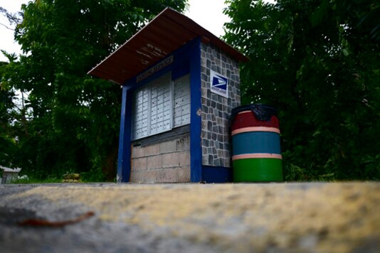 A U.S. Postal Service mailbox stands in a rural area of Caguas, Puerto Rico, Wednesday, Sept. 30, 2020. Many people have their official addresses listed as post office boxes _ with clusters of rusting boxes dotting rural routes around the island _ and don't want to be on a map. (AP Photo/Carlos Giusti) A U.S. Postal Service mailbox stands in a rural area of Caguas, Puerto Rico, Wednesday, Sept. 30, 2020. Many people have their official addresses listed as post office boxes _ with clusters of rusting boxes dotting rural routes around the island _ and don't want to be on a map. (AP Photo/Carlos Giusti)