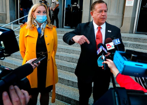 Mark McCloskey addresses the press alongside his wife Patricia on Tuesday, Oct. 6, 2020, outside the Carnahan Courthouse, in St. Louis, Mo. The couple's hearing scheduled for Tuesday was postponed until next week. The McCloskeys were charged in July with brandishing guns at protesters outside their Portland Place mansion in June. (Laurie Skrivan/St. Louis Post-Dispatch via AP) Mark McCloskey addresses the press alongside his wife Patricia on Tuesday, Oct. 6, 2020, outside the Carnahan Courthouse, in St. Louis, Mo. The couple's hearing scheduled for Tuesday was postponed until next week. The McCloskeys were charged in July with brandishing guns at protesters outside their Portland Place mansion in June. (Laurie Skrivan/St. Louis Post-Dispatch via AP)