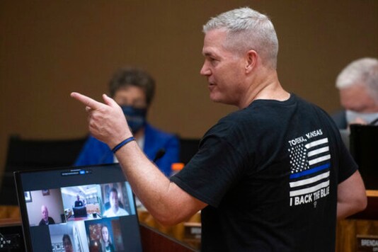 Ron Gish, organizer of the Back the Blue rally which took place prior to the city council special meeting on Aug. 25, 2020, addresses the city council in Topeka, Kan. Some advocates in Topeka see long-standing tensions between the police and the city's 125,000 residents, particularly minorities. But advocates of change have been met by vocal support for the police. (Evert Nelson/The Topeka Capital-Journal via AP) Ron Gish, organizer of the Back the Blue rally which took place prior to the city council special meeting on Aug. 25, 2020, addresses the city council in Topeka, Kan. Some advocates in Topeka see long-standing tensions between the police and the city's 125,000 residents, particularly minorities. But advocates of change have been met by vocal support for the police. (Evert Nelson/The Topeka Capital-Journal via AP)