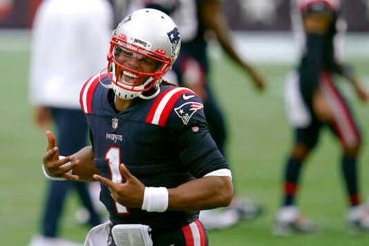 New England Patriots quarterback Cam Newton celebrates after defeating the Las Vegas Raiders in an NFL football game, Sunday, Sept. 27, 2020, in Foxborough, Mass. (AP Photo/Charles Krupa)