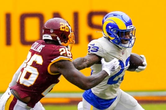 FILE - In this Oct. 11, 2020, file photo, Los Angeles Rams' Cam Akers, right, tries to get past Washington Football Team's Landon Collins during the first half of an NFL football game in Landover, Md. Akers has not made a big impact on the Rams offense near the midway point of his rookie season due to a serious injury and a crowded Los Angeles backfield. The second-round pick remains optimistic about getting a bigger role down the stretch. (AP Photo/Steve Helber, File)