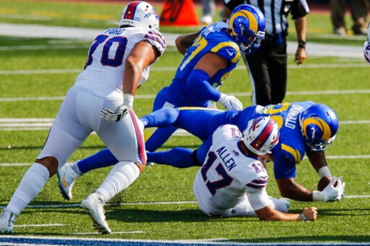 Los Angeles Rams' Aaron Donald recovers the ball after sacking Buffalo Bills' Josh Allen (17) during the second half of an NFL football game Sunday, Sept. 27, 2020, in Orchard Park, N.Y. (AP Photo/John Munson)