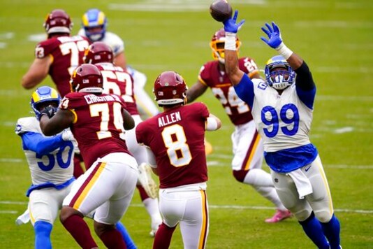 Washington Football Team's Kyle Allen throws with Los Angeles Rams' Aaron Donald rushing during the first half of an NFL football game Sunday, Oct. 11, 2020, in Landover, Md. (AP Photo/Susan Walsh) Washington Football Team's Kyle Allen throws with Los Angeles Rams' Aaron Donald rushing during the first half of an NFL football game Sunday, Oct. 11, 2020, in Landover, Md. (AP Photo/Susan Walsh)
