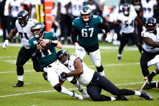 Philadelphia Eagles' Carson Wentz (11) is tackled by Baltimore Ravens' Calais Campbell (93) during the second half of an NFL football game, Sunday, Oct. 18, 2020, in Philadelphia. (AP Photo/Derik Hamilton) Philadelphia Eagles' Carson Wentz (11) is tackled by Baltimore Ravens' Calais Campbell (93) during the second half of an NFL football game, Sunday, Oct. 18, 2020, in Philadelphia. (AP Photo/Derik Hamilton)