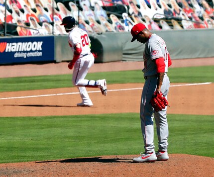 Cincinnati Reds pitcher Raisel Iglesias reacts as Atlanta Braves' Marcell Ozuna rounds the bases after hitting a two-run home run in the eighth inning in Game 2 of a National League wild-card baseball series, Thursday, Oct. 1, 2020, in Atlanta. (Curtis Compton/Atlanta Journal-Constitution via AP)