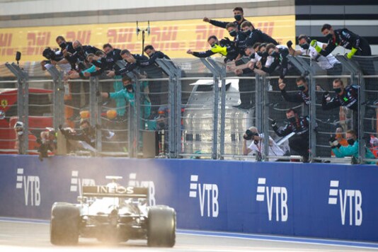 Team members cheer as Mercedes driver Valtteri Bottas of Finland steers his car to win the Russian Formula One Grand Prix, at the Sochi Autodrom circuit, in Sochi, Russia, Sunday, Sept. 27, 2020. (Bryn Lennon, Pool via AP)