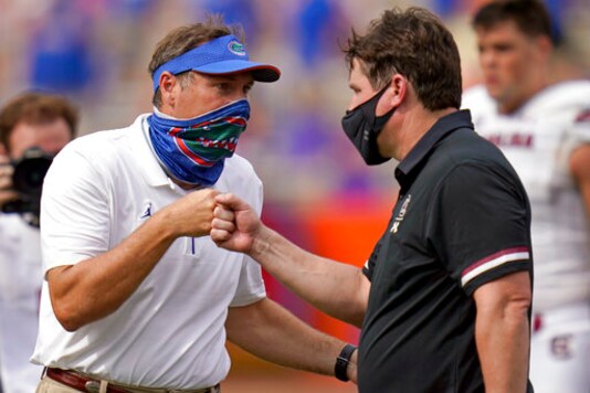 Florida head coach Dan Mullen, left, and South Carolina head coach Will Muschamp bump fists at the end of an NCAA college football game, Saturday, Oct. 3, 2020, in Gainesville, Fla. (AP Photo/John Raoux, Pool) Florida head coach Dan Mullen, left, and South Carolina head coach Will Muschamp bump fists at the end of an NCAA college football game, Saturday, Oct. 3, 2020, in Gainesville, Fla. (AP Photo/John Raoux, Pool)