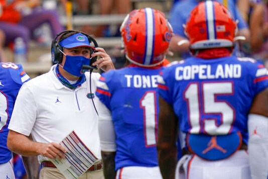 Florida head coach Dan Mullen, left, talks with wide receivers Kadarius Toney (1) and Jacob Copeland (15) during a timeout in the first half of an NCAA college football game against South Carolina, Saturday, Oct. 3, 2020, in Gainesville, Fla. (AP Photo/John Raoux, Pool) Florida head coach Dan Mullen, left, talks with wide receivers Kadarius Toney (1) and Jacob Copeland (15) during a timeout in the first half of an NCAA college football game against South Carolina, Saturday, Oct. 3, 2020, in Gainesville, Fla. (AP Photo/John Raoux, Pool)