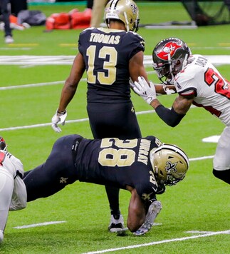 New Orleans Saints running back Latavius Murray (28) lands on wide receiver Michael Thomas' right ankle while being tackled by Tampa Bay Buccaneers safety Antoine Winfield Jr., left, late in the fourth quarter of an NFL football game in New Orleans, Sunday, Sept. 13, 2020. (Andrew Stagni/The Advocate via AP)