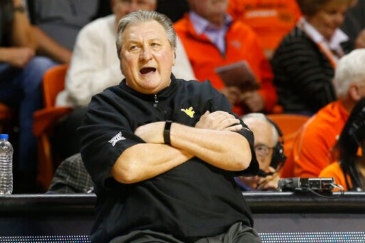 FILE- In this Jan. 6, 2020, file photo, West Virginia head coach Bob Huggins reacts during an NCAA college basketball game against Oklahoma State in Stillwater, Okla. College coaches endured a tense time waiting for for the NCAA to green light the 2020 basketball season. They knew there was a window the NCAA was looking at to start the season, likely sometime in late November or early December. They just didn't have an exact date. So they did the best they could to prepare for the big moment, yet still found themselves in a scramble once it actually happened. (AP Photo/Sue Ogrocki, File) FILE- In this Jan. 6, 2020, file photo, West Virginia head coach Bob Huggins reacts during an NCAA college basketball game against Oklahoma State in Stillwater, Okla. College coaches endured a tense time waiting for for the NCAA to green light the 2020 basketball season. They knew there was a window the NCAA was looking at to start the season, likely sometime in late November or early December. They just didn't have an exact date. So they did the best they could to prepare for the big moment, yet still found themselves in a scramble once it actually happened. (AP Photo/Sue Ogrocki, File)