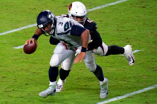Seattle Seahawks quarterback Russell Wilson (3) is hit by Arizona Cardinals outside linebacker Haason Reddick (43) during the second half of an NFL football game, Sunday, Oct. 25, 2020, in Glendale, Ariz. (AP Photo/Ross D. Franklin)