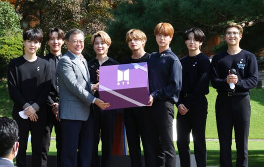 South Korean President Moon Jae-in, third from left, receives a gift from members of South Korean K-Pop group BTS during a ceremony marking the National Youth Day at the presidential Blue House in Seoul, South Korea, Saturday, Sept. 19, 2020. (Lee Jin-wook/Yonhap via AP) South Korean President Moon Jae-in, third from left, receives a gift from members of South Korean K-Pop group BTS during a ceremony marking the National Youth Day at the presidential Blue House in Seoul, South Korea, Saturday, Sept. 19, 2020. (Lee Jin-wook/Yonhap via AP)