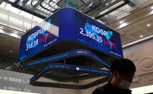 A man wearing a face mask walks near a screen showing the Korea Composite Stock Price Index (KOSPI) at the Korea Exchange in Seoul, South Korea, Thursday, Oct. 8, 2020. Asian shares were mostly higher Thursday on optimism that U.S. stimulus may be coming, as President Donald Trump appeared to reverse his earlier decision to halt talks on another economic rescue effort. (AP Photo/Lee Jin-man) A man wearing a face mask walks near a screen showing the Korea Composite Stock Price Index (KOSPI) at the Korea Exchange in Seoul, South Korea, Thursday, Oct. 8, 2020. Asian shares were mostly higher Thursday on optimism that U.S. stimulus may be coming, as President Donald Trump appeared to reverse his earlier decision to halt talks on another economic rescue effort. (AP Photo/Lee Jin-man)