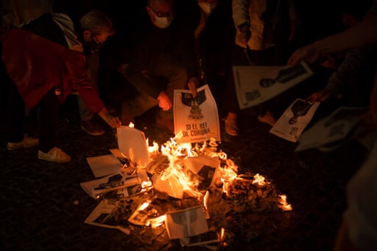 Protestors burn photographs depicting Spain's King Felipe during a demonstration ahead of a meeting between King Felipe and Spanish Prime Minister Pedro Sanchez in Barcelona on Thursday, Oct. 8, 2020. (AP Photo/Emilio Morenatti) Protestors burn photographs depicting Spain's King Felipe during a demonstration ahead of a meeting between King Felipe and Spanish Prime Minister Pedro Sanchez in Barcelona on Thursday, Oct. 8, 2020. (AP Photo/Emilio Morenatti)