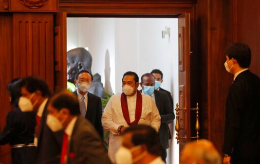 Yang Jiechi, Director of the Central Foreign Affairs Commission of the Chinese Communist Party, center left, and Sri Lankan Prime Minister Mahinda Rajapaksa, center right, arrive for a meeting in Colombo, Sri Lanka, Friday, Oct. 9, 2020. A high level Chinese delegation led by Yang Jiechi met Sri Lankan leaders including president Gotabaya Rajapksa to discuss strengthening of economic ties between the two countries. (AP Photo/Eranga Jayawardena) Yang Jiechi, Director of the Central Foreign Affairs Commission of the Chinese Communist Party, center left, and Sri Lankan Prime Minister Mahinda Rajapaksa, center right, arrive for a meeting in Colombo, Sri Lanka, Friday, Oct. 9, 2020. A high level Chinese delegation led by Yang Jiechi met Sri Lankan leaders including president Gotabaya Rajapksa to discuss strengthening of economic ties between the two countries. (AP Photo/Eranga Jayawardena)