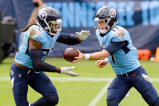 Tennessee Titans quarterback Ryan Tannehill (17) hands the ball off to running back Derrick Henry (22) in the first half of an NFL football game against the Pittsburgh Steelers Sunday, Oct. 25, 2020, in Nashville, Tenn. (AP Photo/Mark Zaleski)