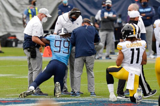 Tennessee Titans linebacker Jadeveon Clowney (99) is helped up after being injured in the second half of an NFL football game against the Pittsburgh Steelers Sunday, Oct. 25, 2020, in Nashville, Tenn. (AP Photo/Mark Zaleski)