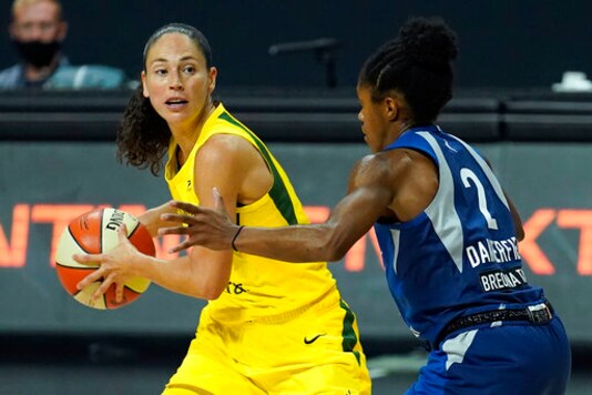 Seattle Storm guard Sue Bird (10) looks to pass around Minnesota Lynx guard Crystal Dangerfield (2) during the second half of Game 3 of a WNBA basketball semifinal round playoff series Sunday, Sept. 27, 2020, in Bradenton, Fla. (AP Photo/Chris O'Meara)