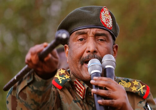 FILE - In this June 29, 2019 file photo, Sudanese Gen. Abdel-Fattah Burhan, head of the military council, speaks during a military-backed rally, in Omdurman district, west of Khartoum, Sudan. Officials in Sudan confirmed that a senior U.S.-Israeli delegation flew to Sudan on a private jet Wednesday, Oct. 21, 2020, and met with Burhan and others to wrap up a deal that would make Sudan the third Arab country to normalize ties with Israel this year. (AP Photo/Hussein Malla, File) FILE - In this June 29, 2019 file photo, Sudanese Gen. Abdel-Fattah Burhan, head of the military council, speaks during a military-backed rally, in Omdurman district, west of Khartoum, Sudan. Officials in Sudan confirmed that a senior U.S.-Israeli delegation flew to Sudan on a private jet Wednesday, Oct. 21, 2020, and met with Burhan and others to wrap up a deal that would make Sudan the third Arab country to normalize ties with Israel this year. (AP Photo/Hussein Malla, File)