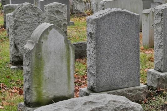 FILE - This Dec. 11, 2019 file photo shows gravestones at a cemetery in New Jersey. The U.S. suicide death rate fell slightly in 2019, the first annual decline in more than a decade, according to new government data. (AP Photo/Seth Wenig) FILE - This Dec. 11, 2019 file photo shows gravestones at a cemetery in New Jersey. The U.S. suicide death rate fell slightly in 2019, the first annual decline in more than a decade, according to new government data. (AP Photo/Seth Wenig)