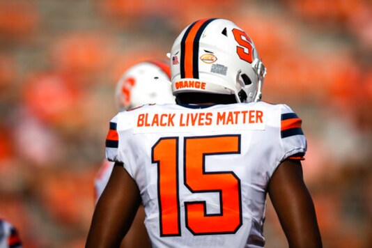 Syracuse quarterback JaCobian Morgan (15) wears a jersey with Black Lives Matter printed on the back during an NCAA college football game against Clemson in Clemson, S.C., on Saturday, Oct. 24, 2020. (Ken Ruinard/Pool Photo via AP) Syracuse quarterback JaCobian Morgan (15) wears a jersey with Black Lives Matter printed on the back during an NCAA college football game against Clemson in Clemson, S.C., on Saturday, Oct. 24, 2020. (Ken Ruinard/Pool Photo via AP)