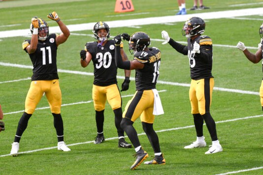 Pittsburgh Steelers wide receiver JuJu Smith-Schuster (19) dances with teammates in the end zone after catching a pass against the Houston Texans and running it in for a touchdown in the first half of an NFL football game, Sunday, Sept. 27, 2020, in Pittsburgh. (AP Photo/Don Wright)