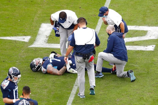 Tennessee Titans offensive tackle Taylor Lewan (77) lies on the ground after being injured in the second half of an NFL football game against the Houston Texans Sunday, Oct. 18, 2020, in Nashville, Tenn. (AP Photo/Wade Payne) Tennessee Titans offensive tackle Taylor Lewan (77) lies on the ground after being injured in the second half of an NFL football game against the Houston Texans Sunday, Oct. 18, 2020, in Nashville, Tenn. (AP Photo/Wade Payne)