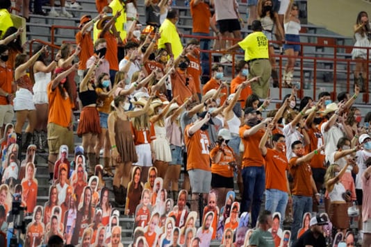 FILE - In this Saturday, Sept. 12, 2020, file photo, fans join in singing FILE - In this Saturday, Sept. 12, 2020, file photo, fans join in singing