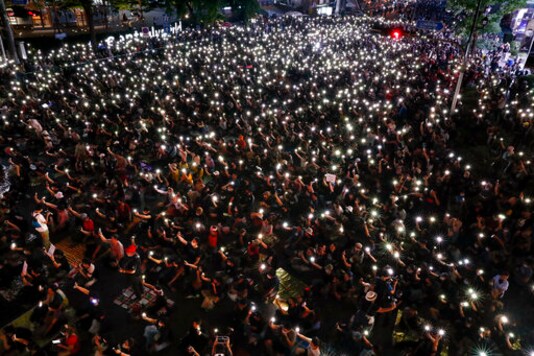 Pro-democracy activists wave their mobile phone with flashing lights during a protest rally at Ratchaprasong business district in Bangkok, Thailand, Sunday, Oct. 25, 2020. Pro-democracy protesters in Thailand gathered again on Sunday in Bangkok, seeking to keep up pressure on the government a day ahead of a special session of Parliament called to try to ease political tensions. (AP Photo/Gemunu Amarasinghe) Pro-democracy activists wave their mobile phone with flashing lights during a protest rally at Ratchaprasong business district in Bangkok, Thailand, Sunday, Oct. 25, 2020. Pro-democracy protesters in Thailand gathered again on Sunday in Bangkok, seeking to keep up pressure on the government a day ahead of a special session of Parliament called to try to ease political tensions. (AP Photo/Gemunu Amarasinghe)