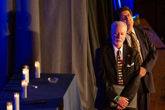 FILE - In this Sunday, Oct. 27, 2019 file photo, Rabbis Jeffrey Myers, left, of Tree of Life/Or L'Simcha Congregation and Jonathan Perlman of New Light Congregation wait on stage before speaking to standing-room only crowd gathered for the one-year commemoration of the Tree of Life synagogue attack, at Soldiers & Sailors Memorial Hall and Museum in Pittsburgh. Since March 2020, Tree of Life has halted all in-person worship and group activities. However, Rabbi Myers has made appearances on Zoom and Facebook, livestreamed from his living room. During the pandemic, people are seeking community, he said. We try in any way to help them find solace and hope and inspiration. (AP Photo/Rebecca Droke)