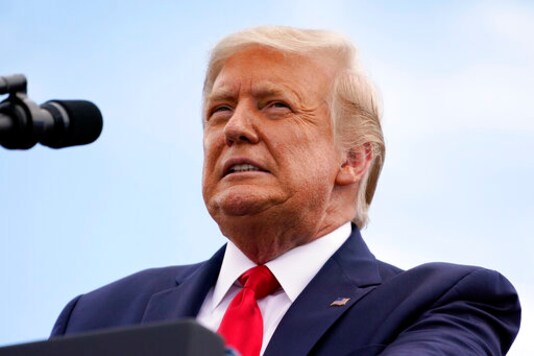 President Donald Trump speaks on the environment at the Jupiter Inlet Lighthouse and Museum in Jupiter, Fla., Tuesday, Sept. 8, 2020. The U.S. Justice Department is seeking to take over the president's defense in a defamation lawsuit from a woman who accused him of rape, and federal lawyers asked a court Tuesday to allow a legal move that could put the American people on the hook for any money she might be awarded. Columnist E. Jean Carroll is suing the president for comments he made denying her rape allegations in 2019, saying his comments, including that she was totally lying to sell a memoir, besmirched her character and harmed her career. (AP Photo/Evan Vucci) President Donald Trump speaks on the environment at the Jupiter Inlet Lighthouse and Museum in Jupiter, Fla., Tuesday, Sept. 8, 2020. The U.S. Justice Department is seeking to take over the president's defense in a defamation lawsuit from a woman who accused him of rape, and federal lawyers asked a court Tuesday to allow a legal move that could put the American people on the hook for any money she might be awarded. Columnist E. Jean Carroll is suing the president for comments he made denying her rape allegations in 2019, saying his comments, including that she was totally lying to sell a memoir, besmirched her character and harmed her career. (AP Photo/Evan Vucci)