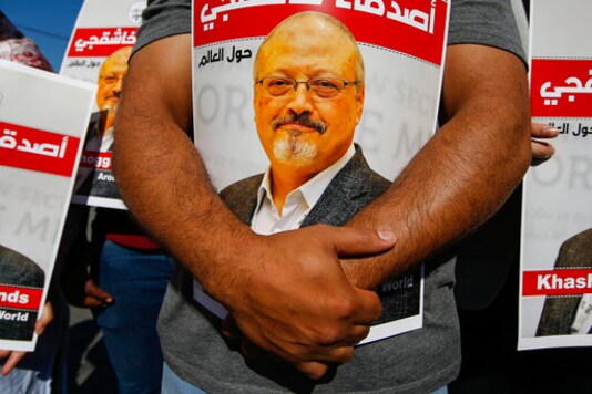 People hold posters of slain Saudi journalist Jamal Khashoggi, near the Saudi Arabia consulate in Istanbul, marking the two-year anniversary of his death, Friday, Oct. 2, 2020. The gathering was held outside the consulate building, starting at 1:14 p.m. (1014 GMT) marking the time Khashoggi walked into the building where he met his demise. The posters read in Arabic:' Khashoggi's Friends Around the World'. (AP Photo/Emrah Gurel) People hold posters of slain Saudi journalist Jamal Khashoggi, near the Saudi Arabia consulate in Istanbul, marking the two-year anniversary of his death, Friday, Oct. 2, 2020. The gathering was held outside the consulate building, starting at 1:14 p.m. (1014 GMT) marking the time Khashoggi walked into the building where he met his demise. The posters read in Arabic:' Khashoggi's Friends Around the World'. (AP Photo/Emrah Gurel)