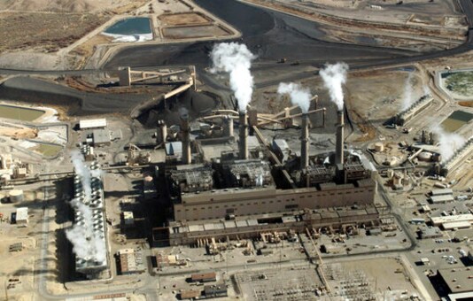 FILE - This Nov. 9, 2009, file photo shows the coal-fired San Juan Generating Station near Farmington, N.M. The parent company of New Mexicos largest electric utility will become part of energy giant Iberdrolas global holdings under a multibillion-dollar merger. Under the agreement announced Wednesday, Oct. 21, 2020, Iberdrola's majority-owned U.S. subsidiary Avangrid will acquire PNM Resources and its assets in New Mexico and Texas. The merger will require approval from a number of state and federal regulators in a process that's expected to take the next 12 months. (AP Photo/Susan Montoya Bryan, File)