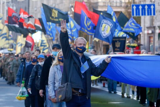 People carry the Ukrainian National flag at a rally marking Defender of Ukraine Day in centre Kyiv, Ukraine, Wednesday, Oct. 14, 2020. (AP Photo/Efrem Lukatsky) People carry the Ukrainian National flag at a rally marking Defender of Ukraine Day in centre Kyiv, Ukraine, Wednesday, Oct. 14, 2020. (AP Photo/Efrem Lukatsky)