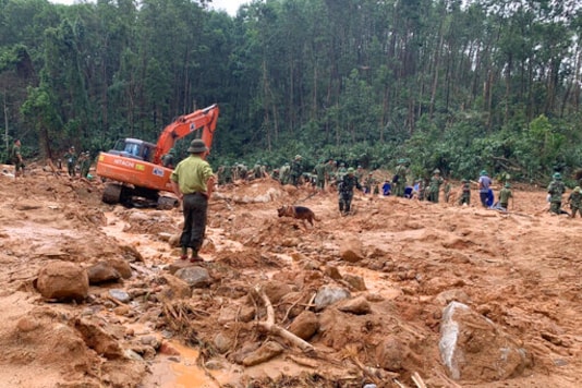Rescue workers recover bodies of army officers buried in a landslide in Thua Thien-Hue province, Vietnam, Thursday, Oct. 15, 2020. Rescuers recovered the bodies of 11 army personnel and two other people who were buried in the landslide while trying to reach victims of another landslide, state media reported Friday, Oct. 16, 2020. (Tran Le Lam/VNA via AP) Rescue workers recover bodies of army officers buried in a landslide in Thua Thien-Hue province, Vietnam, Thursday, Oct. 15, 2020. Rescuers recovered the bodies of 11 army personnel and two other people who were buried in the landslide while trying to reach victims of another landslide, state media reported Friday, Oct. 16, 2020. (Tran Le Lam/VNA via AP)
