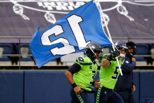 Seattle Seahawks' Cody Barton carries the 12th flag onto the field as he runs with quarterback Russell Wilson before an NFL football game against the Minnesota Vikings, Sunday, Oct. 11, 2020, in Seattle. (AP Photo/John Froschauer) Seattle Seahawks' Cody Barton carries the 12th flag onto the field as he runs with quarterback Russell Wilson before an NFL football game against the Minnesota Vikings, Sunday, Oct. 11, 2020, in Seattle. (AP Photo/John Froschauer)