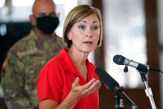 FILE - In this Friday, Aug. 14, 2020, file photo, Iowa Gov. Kim Reynolds speaks during a news conference, in Cedar Rapids, Iowa. Hospitalizations from COVID-19 have hit their highest points recently throughout the Midwest, where the growth in new cases has been the worst in the nation. In Iowa, which has eased most of its earlier coronavirus restrictions, COVID-19 hospitalizations also hit a record high last week. Gov. Kim Reynolds, however, has defended the state's decision to reopen bars and send students back into classrooms without masks required. (AP Photo/Charlie Neibergall, File) FILE - In this Friday, Aug. 14, 2020, file photo, Iowa Gov. Kim Reynolds speaks during a news conference, in Cedar Rapids, Iowa. Hospitalizations from COVID-19 have hit their highest points recently throughout the Midwest, where the growth in new cases has been the worst in the nation. In Iowa, which has eased most of its earlier coronavirus restrictions, COVID-19 hospitalizations also hit a record high last week. Gov. Kim Reynolds, however, has defended the state's decision to reopen bars and send students back into classrooms without masks required. (AP Photo/Charlie Neibergall, File)