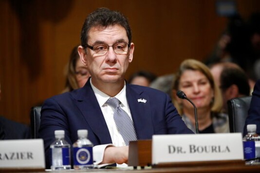 FILE - In this Feb. 26, 2019 file photo, Albert Bourla, chief executive officer of Pfizer, prepares to testify before the Senate Finance Committee hearing on drug prices, on Capitol Hill in Washington. Pfizer Inc.'s CEO says it can't seek emergency authorization of its COVID-19 vaccine before the third week of November and that's if everything goes well. The announcement on Friday, Oct. 16, 2020, by Bourla reflects estimates from leading scientists that its unlikely data would start to emerge until November or December showing any of the leading vaccine candidates work. (AP Photo/Pablo Martinez Monsivais, File) FILE - In this Feb. 26, 2019 file photo, Albert Bourla, chief executive officer of Pfizer, prepares to testify before the Senate Finance Committee hearing on drug prices, on Capitol Hill in Washington. Pfizer Inc.'s CEO says it can't seek emergency authorization of its COVID-19 vaccine before the third week of November and that's if everything goes well. The announcement on Friday, Oct. 16, 2020, by Bourla reflects estimates from leading scientists that its unlikely data would start to emerge until November or December showing any of the leading vaccine candidates work. (AP Photo/Pablo Martinez Monsivais, File)