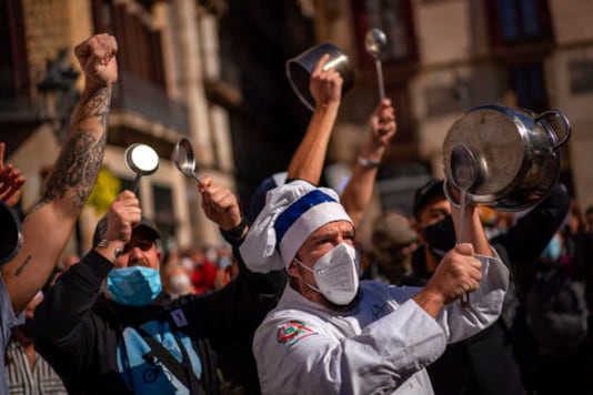 FILE - In this Friday, Oct. 16, 2020 file photo, workers of catering sectors take part in a protest organized by restaurants and bar owners in Barcelona, Spain. The coronavirus pandemic is gathering strength again in Europe and, with winter coming, its restaurant industry is struggling. The spring lockdowns were already devastating for many, and now a new set restrictions is dealing a second blow. Some governments have ordered restaurants closed; others have imposed restrictions curtailing how they operate. (AP Photo/Emilio Morenatti, File) FILE - In this Friday, Oct. 16, 2020 file photo, workers of catering sectors take part in a protest organized by restaurants and bar owners in Barcelona, Spain. The coronavirus pandemic is gathering strength again in Europe and, with winter coming, its restaurant industry is struggling. The spring lockdowns were already devastating for many, and now a new set restrictions is dealing a second blow. Some governments have ordered restaurants closed; others have imposed restrictions curtailing how they operate. (AP Photo/Emilio Morenatti, File)