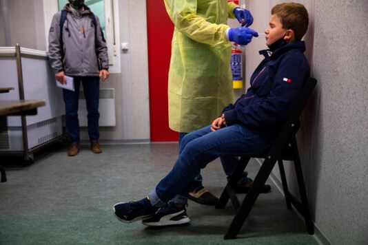 A medical worker, wearing full protective gear, takes a nose swab from a patient to be tested for COVID-19 in a Red Cross test center in Brussels, Tuesday, Oct. 20, 2020. Bars and restaurants across Belgium shut down for a month and a night-time curfew entered into force Monday in the hard-hit coronavirus country as health authorities warned of a possible sanitary tsunami. A medical worker, wearing full protective gear, takes a nose swab from a patient to be tested for COVID-19 in a Red Cross test center in Brussels, Tuesday, Oct. 20, 2020. Bars and restaurants across Belgium shut down for a month and a night-time curfew entered into force Monday in the hard-hit coronavirus country as health authorities warned of a possible sanitary tsunami.